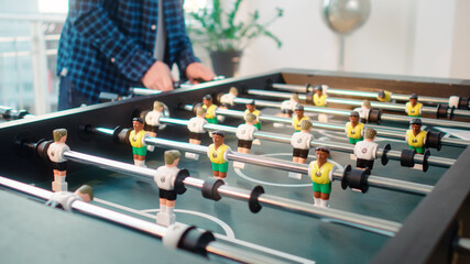 Close up of table soccer game miniatur football germany vs brasil white versus yellow 