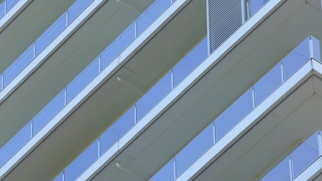diagonal lines of a building in blue with glass and concrete