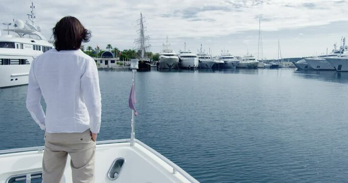 Man from behind standing on a boat sailing into the seagate - Cinematic scene with RED Camera 4K H264