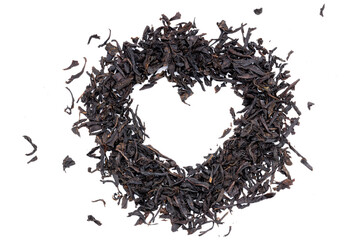 dry black tea heap isolated on white background. indian dried tea leaf cut out. heart shape