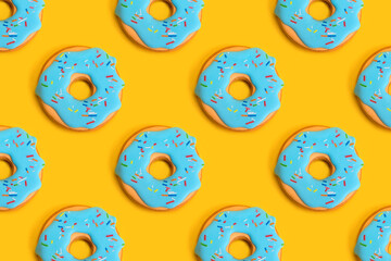 Background pattern of gingerbread donuts at the yellow background, concept