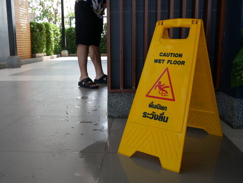 caution wet floor sign at public toilet.