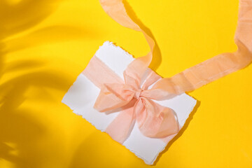 Bridal invitation card in an envelope with silk ribbon