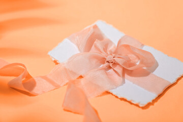 Bridal invitation card in an envelope with silk ribbon