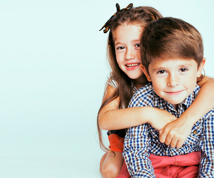 little cute boy and girl hugging playing on white background, happy smiling family, lifestyle people concept