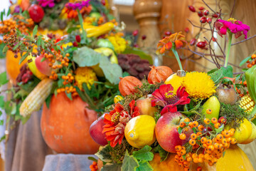 Obraz na płótnie Canvas Autumn thanksgiving arrangement with flowers and autumn fruits, pumpkins, apples, sempervivum, colorful background