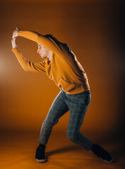 Contemporary style dancer on orange wall