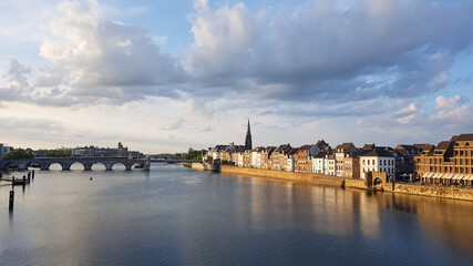 Fototapeta na wymiar View to Maastricht from the pedestrian bridge over Meuse River at the sunset. Netherlands.
