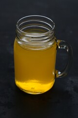 Glass of fresh orange juice isolated on black background.