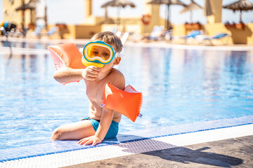 Kids snorkel. Little boy snorkeling in swimming pool on summer vacation. Child with mask.