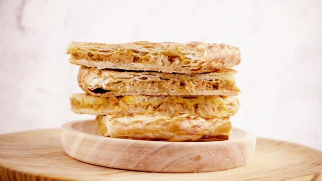 Closeup of portions of empanada with natural ingredients such a tomato, onion, pepper, tuna, egg and dough of wheat on a white background. Tuna pie. Typical Galician dish from Galicia and Spain