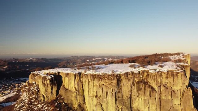 Huge flat rock on italian appennini mountains with snow