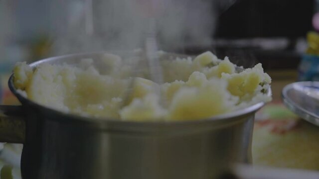 Close-up, Elderly Woman's Hand Tolch Freshly Cooked Potato Puree in Metal Bar