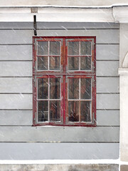 Fototapeta na wymiar Antique loosely bound window in european city, selective focus