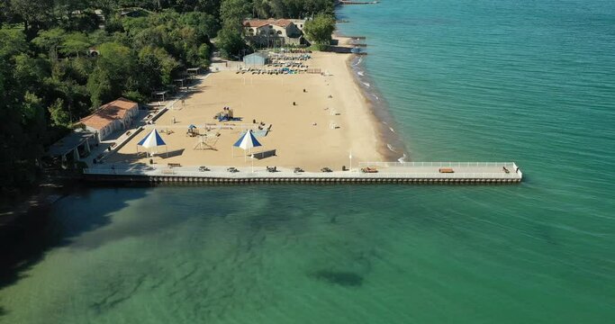 Aerial of a beautiful suburban beach with pier and big sandy area