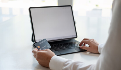 girl makes a purchase on the Internet on the smart tablet with credit card - online shopping concept.