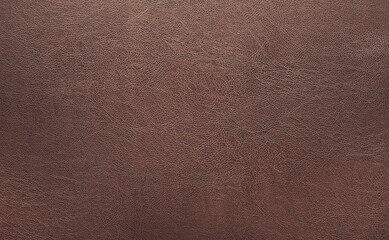 Dark brown rough leather texture background. Closeup detail of parchment quality.