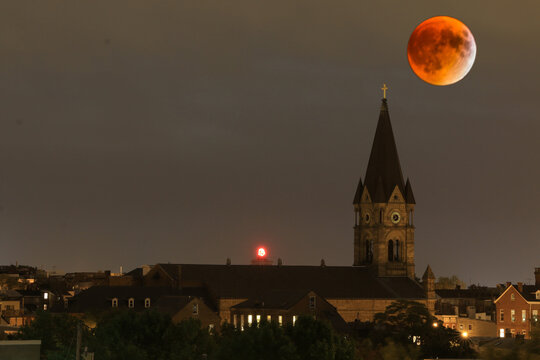 orange colored harvest full moon in Baltimore City, Maryland.
