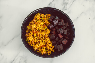 vegan asian fried rice with nutritional yeat and marinated tofu cubes, healthy plant-based food