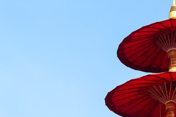 Red umbrella on bright blue sky and copy space