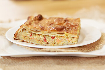 Chicken and potato pie on the dining table. The food is ready to eat. Puff pastry. kitchen utensils for cooking