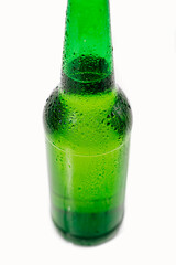 green glass bottle covered with water drops. condensate