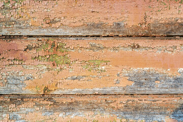 Brown orange boards. Old, cracked and peeled paint. Aged dilapidated wall. Rustic background. Place for text, copy space.
