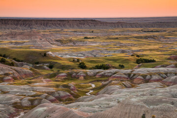 beautiful summer sunset on the sprawling vista of the Badlands National Park in South Dakota.