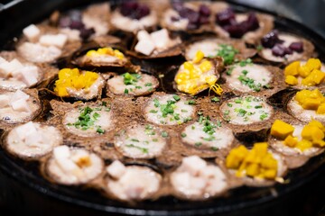 Close up of Knmcrk Thai dessert made from coconut milk in the pan, thai street food market