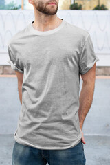 Man wearing minimal gray t-shirt fashion apparel outdoor shoot