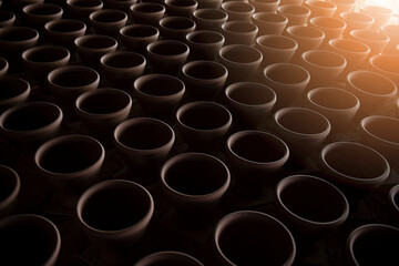 A narrow depth-of-field, blurred background and a large traditional indigenous pottery jar sits side-by-side in an Asian stone mortar pottery.