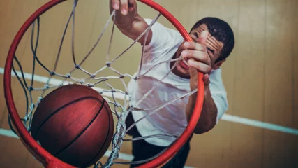 Fotobehang Basketball player making a slam dunk wallpaper © Rawpixel.com