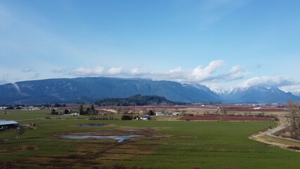 Fototapeta premium Drone shot of Farmland back by mountains