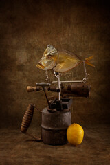 Still life with moonfish, blowtorch and lemon