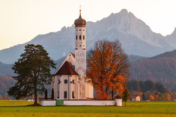 Beautiful view of the Saint Coloman church near the Neuschwanstein castle, against the backdrop of the beautiful mountains, Schwangau in the Bavarian province