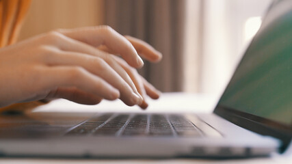 Fototapeta na wymiar typing on laptop keyboard internet close-up work communication
