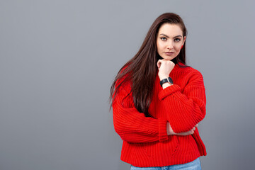 headshot of a happy emotional teenage girl with long hair dressed in a red sweater and jeans