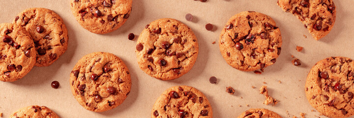 Chocolate chip cookies with melting chocolate panorama, top shot on brown paper