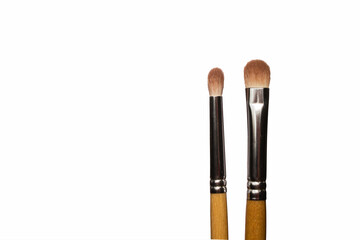 Two natural bristle brushes for applying and blending eye shadow isolated on white