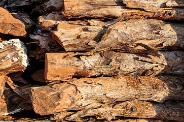 A pile of stacked firewood. Natural wooden background.