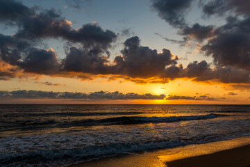 Fototapeta na wymiar Dramatic sunset over ocean. Sky with clouds.
