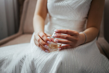 The girl holds a perfume in her hands. Perfume in women's hands. Aromatherapy. Perfume.