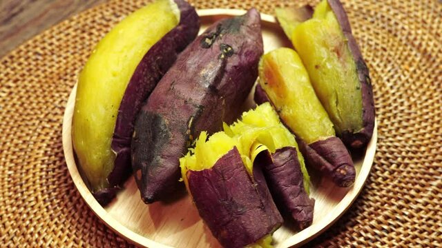 Top view rotate baked sweet potato closeup, Japanese Roasted Sweet Potato on wooden table in garden.