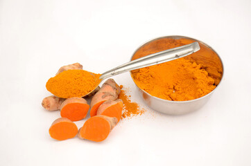 the sliced turmeric with spoon bowl powder isolated on white background.