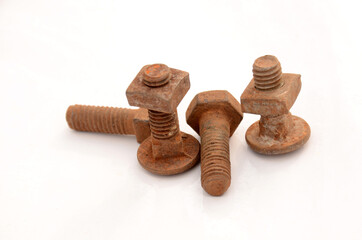 the orange color rusty iron bolt nut isolated on white background.
