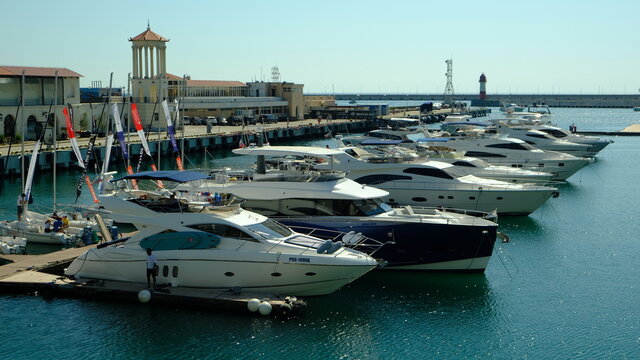 Sochi, Russia - 20 AUG 2020: Sea port, boats and yachts at the pier in Sochi, Russia. Black Sea landscape.