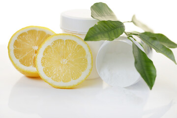 Vitamin C powder .White jar and measuring spoon, vitamin C white powder and lemons in a cut on a...