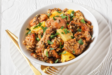 braised Rabbit with potatoes in a white bowl