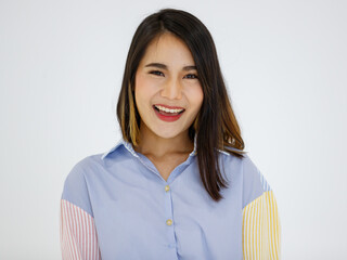 Image of happy young Asian woman posing isolated over grey wall background with friendly positive face