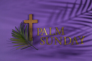 Palm sunday background. Cross and palm on purple background.